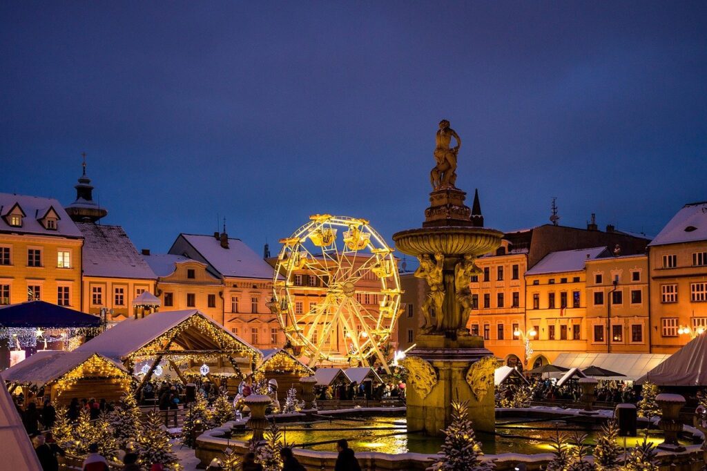 a winter market in a town square with historic buildings covered in snow for writing inspiration
